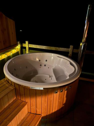 a large jacuzzi tub in a room at night at The Forest House in La Comballaz