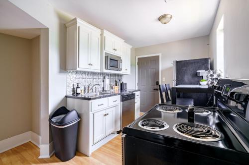 a kitchen with a stove top oven next to a sink at Jungle House Luxury Stays - Columbus Downtown Short North in Columbus