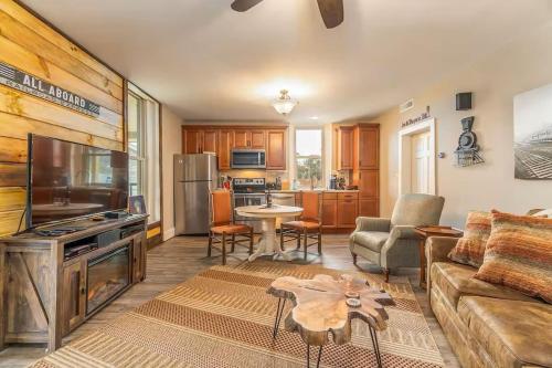 a living room with a couch and a table at All Aboard Stylish Downtown Loft, Walk to Restaurants, Shops, Train in Bryson City