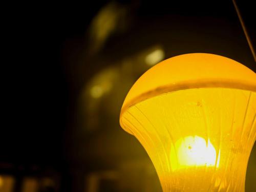 a close up of a yellow lamp shade at LUXUS INN JA Star in Chacka