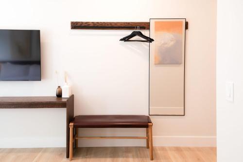 a mirror in a living room with a stool at Boardwalk Suites & Residences By Kasa in Traverse City