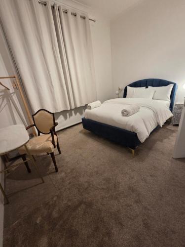 a bedroom with a large bed and a chair at Camden Mia Apa in London