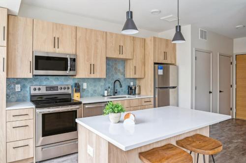 a kitchen with wooden cabinets and a white counter top at Kasa Bryn Mawr Minneapolis in Minneapolis