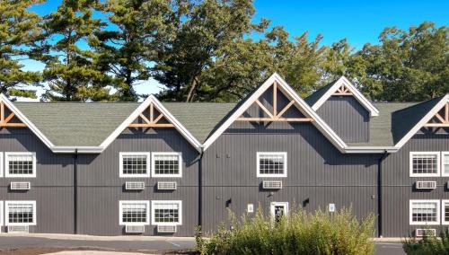 a large gray barn with white windows at The Vic By Kasa in Traverse City