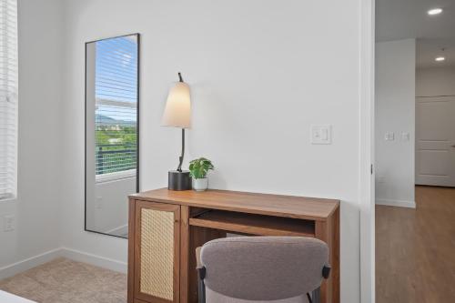 a desk with a lamp and a chair in a room at Kasa On The River Boise in Boise