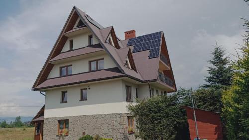 a house with solar panels on its roof at Dom Wypoczynkowy Słoneczny in Białka Tatrzanska