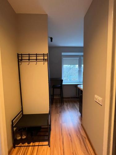 a room with a closet with a desk and a chair at Cozy Stay Dubulti in Jūrmala