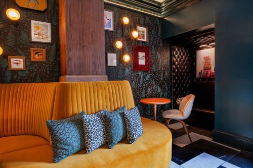 a living room with a couch with pillows on it at The Bell Athens By Kasa Living in Athens
