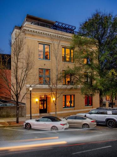 two cars parked in a parking lot in front of a building at The Bell Athens By Kasa Living in Athens