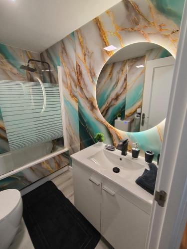 a bathroom with a sink and a mirror at Luxury A Huertas 143 in Tomelloso