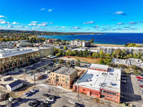 an aerial view of a city with the ocean at The Loop Downtown By Kasa in Traverse City