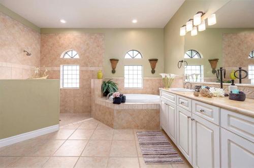 a large bathroom with a tub and a sink at Surfside in Cape Coral