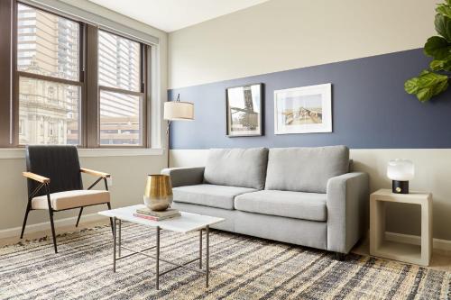 a living room with a couch and a table at Kasa Cadillac Square Detroit in Detroit