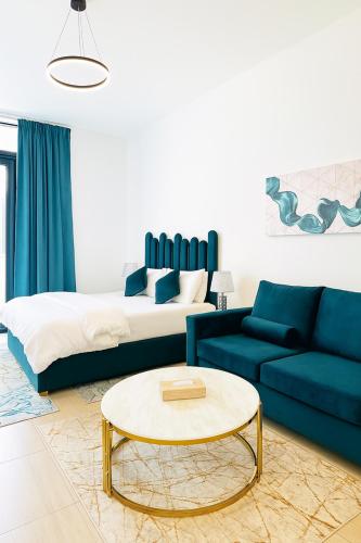 a living room with a bed and a coffee table at Stunning Studio in Dubai in Dubai