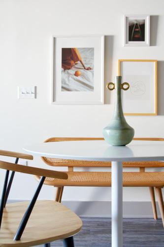a table and chairs with a vase on top of it at Kasa Altmayer Savannah in Savannah