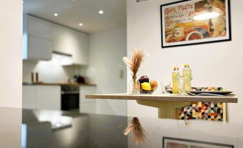 a table with a bowl of fruit on it in a kitchen at Au Petit Pierrot in Spa