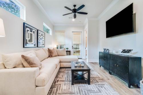 a living room with a couch and a flat screen tv at Brand New Designer Townhome in the Middle of Town in Lafayette