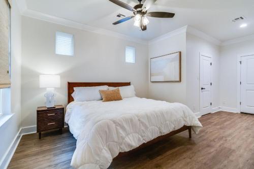 a white bedroom with a bed and a ceiling fan at Brand New Designer Townhome in the Middle of Town in Lafayette