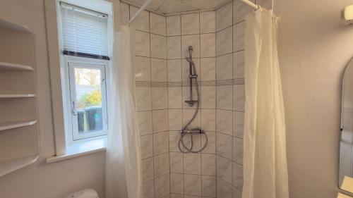 a bathroom with a shower with a shower curtain at Apartment in the heart of Esbjerg Center in Esbjerg