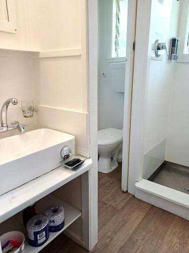 a bathroom with a sink and a toilet at Waitangi Beach Unit B in Paihia
