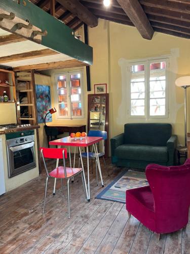 a living room with a table and chairs and a couch at fienile di frida in Lucca