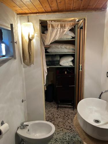 a bathroom with a sink and a toilet and a mirror at fienile di frida in Lucca