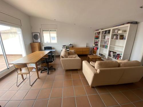 a living room with a couch and a table at Stunning Villa 25' from Barcelona in Las Canteras