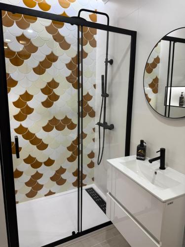 a bathroom with a shower with a sink and a mirror at Apartamento Cavaleiro in Nazaré