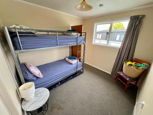 a room with two bunk beds in it with a window at Mackenzie Cottage in Twizel