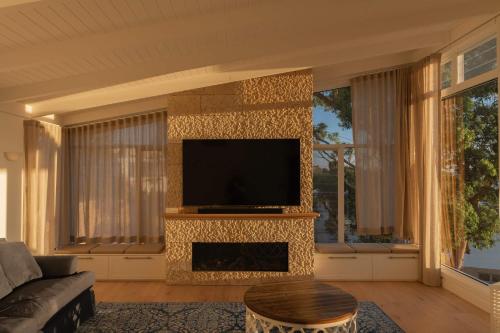 a living room with a flat screen tv on a wall at Oceano House in Copacabana