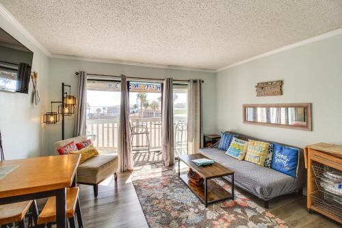 a living room with a couch and a table at Steps to Water! Beachfront Corpus Christi Condo in Corpus Christi