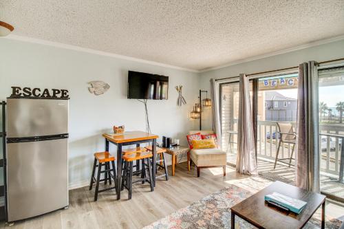 a kitchen and living room with a table and a refrigerator at Steps to Water! Beachfront Corpus Christi Condo in Corpus Christi