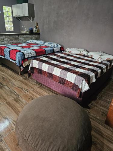 two beds sitting next to each other in a room at Recanto do Descanso in São Gabriel