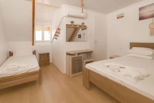 a small room with two beds and a staircase at Giorgos House Attic in Gialova