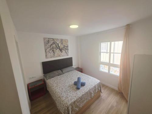 a bedroom with a bed with a blue cross on it at Spacious 3BR Condo With Pool, Wifi & Near Beach in Callao Salvaje