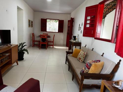 a living room with a couch and a table at Casa Alegria - Praia de Catuama -PE in Goiana
