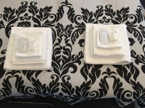 two white napkins on a black and white wallpaper at Valentine's White Lux in Kuldīga