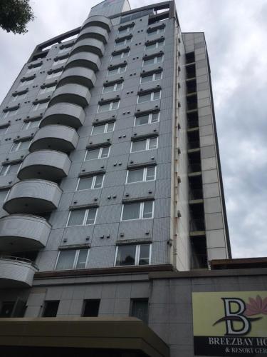 a tall building with a sign in front of it at Breezbay Hotel & Resort Gero in Gero
