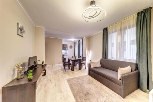 a living room with a couch and a table at Warm Mountain Hideout by Flat Manаger in Pamporovo
