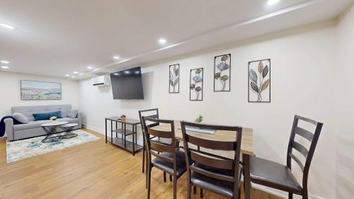 a living room with a table and chairs and a couch at Cozy Basement Apartment for 4 - Near Cafes & Parks in Toronto