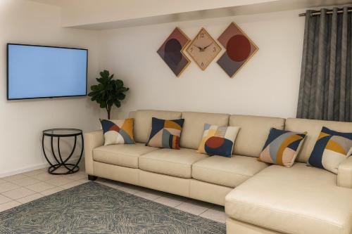 a living room with a couch and a screen at Serenity Cove -2 Bedroom Apartment in Newark