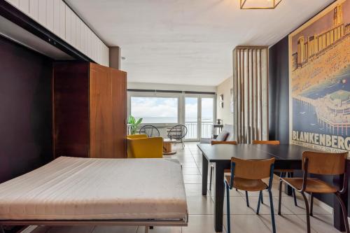 a dining room with a table and chairs at superSEAVIEW - uniek ZEEZICHT in Blankenberge
