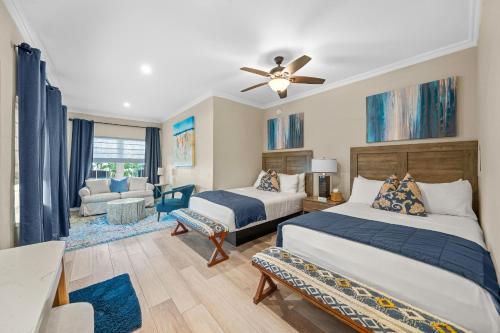 a bedroom with two beds and a living room at Bleu Beach Resort in Indialantic