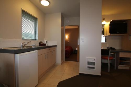 a kitchen with a sink and a counter top at Bella Vista Motel Kaikoura in Kaikoura