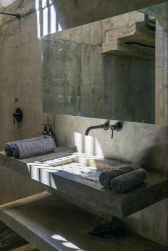 a stone bathroom with a sink and a mirror at Nativo Tayrona in Santa Marta