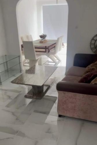 a living room with a couch and a table at 4 Bed Detached Home Perfect for Families & Groups in Glasgow