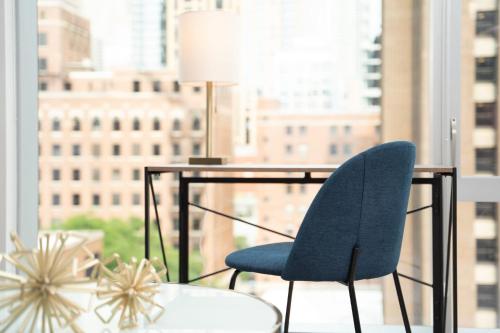 a blue chair sitting at a desk in front of a window at Kasa River North Chicago in Chicago