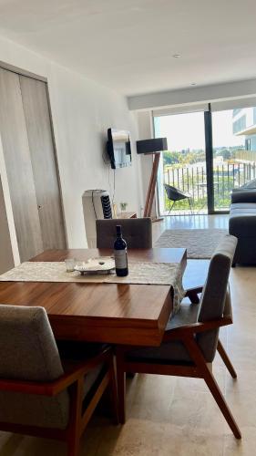 a wooden table and chairs in a living room at #1 in Andares Pool-Jacuzzi-We invoice free of charge in Guadalajara