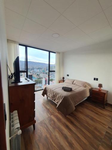 Кровать или кровати в номере Hermoso, cálido y con vista espectacular departamento
