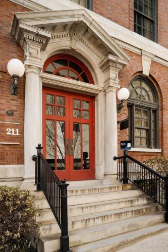 a red door on a brick building with stairs at Kasa Capitol Hill Downtown Nashville in Nashville